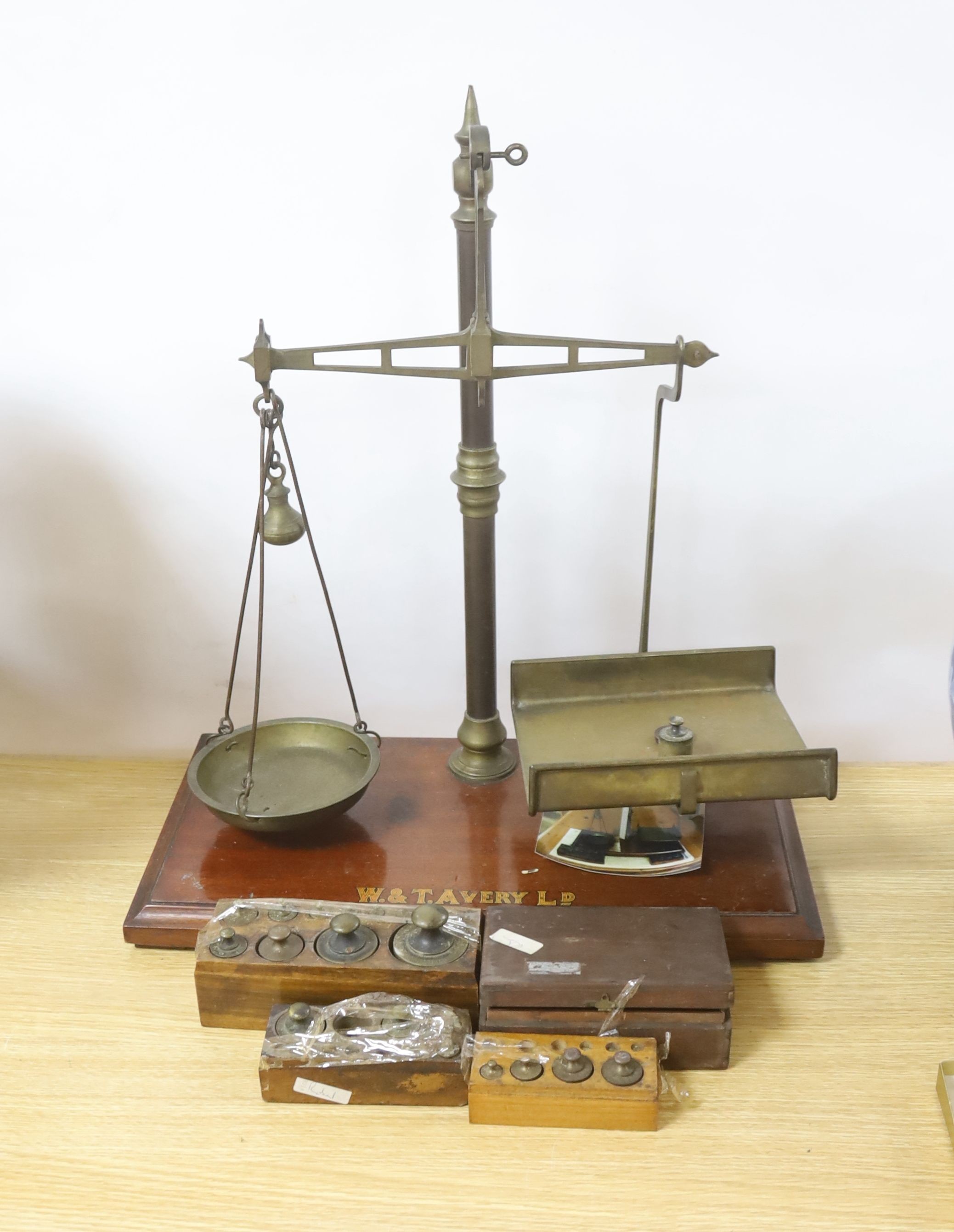 A large W.&T.Avery brass beam scales with weights, 59cm